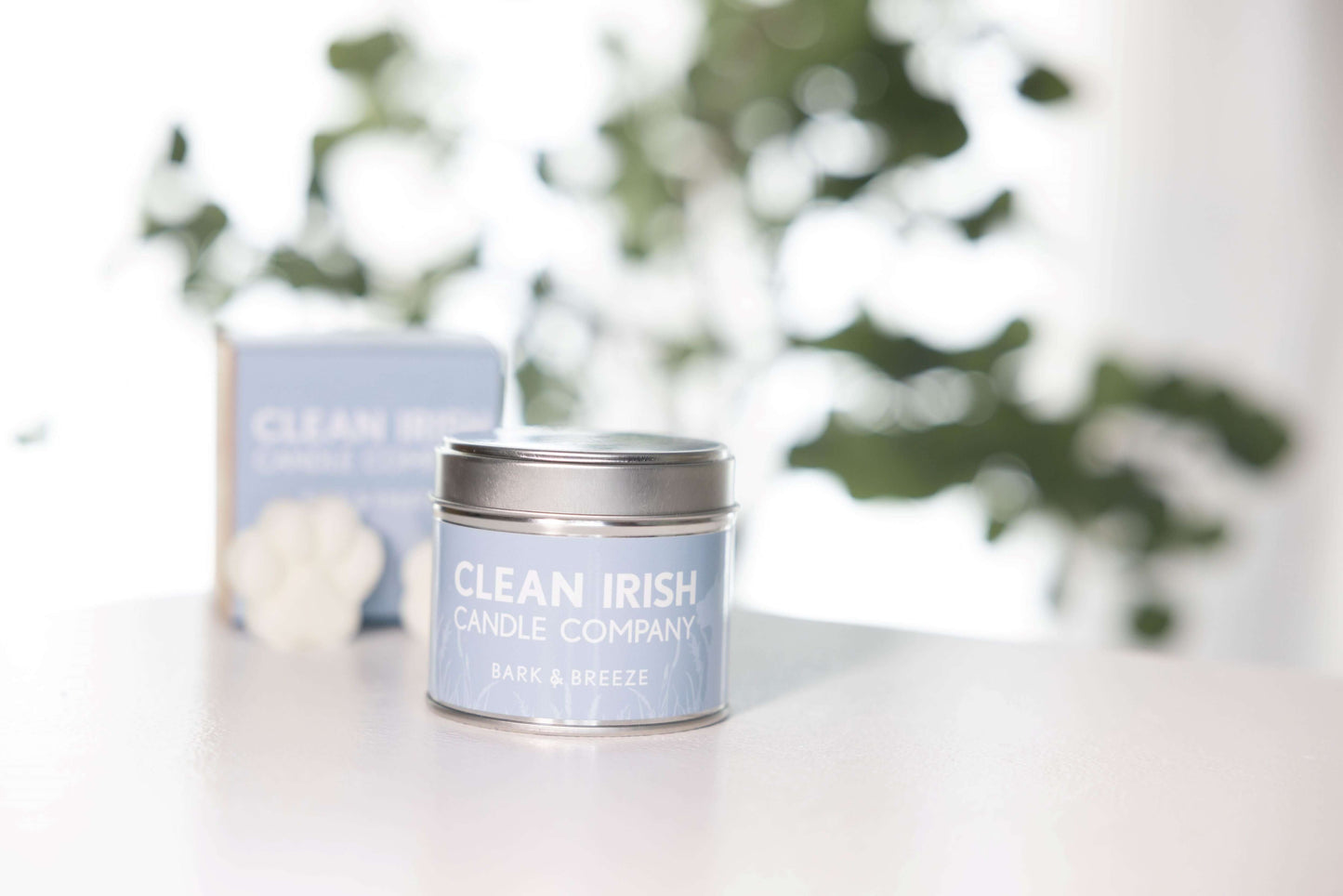 Bark & Breeze Non-toxic Irish Scented Soy Candle in a clean, airy setting with greenery.