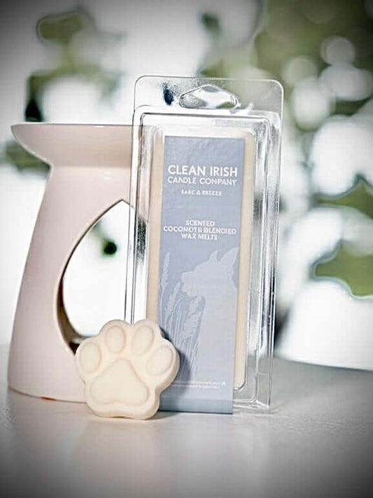 Bark & Breeze Non-toxic Irish Scented Wax Melts next to a wax warmer and paw-shaped wax melt.